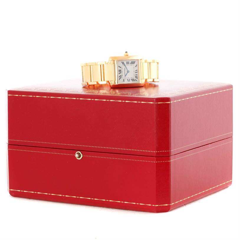 The Cartier Tank Francaise W50003N2 Women's Yellow Gold Silver Dial W50003N2 Women's Yellow Gold Silver Dial watch is shown from a slight side angle, resting on a closed red box.