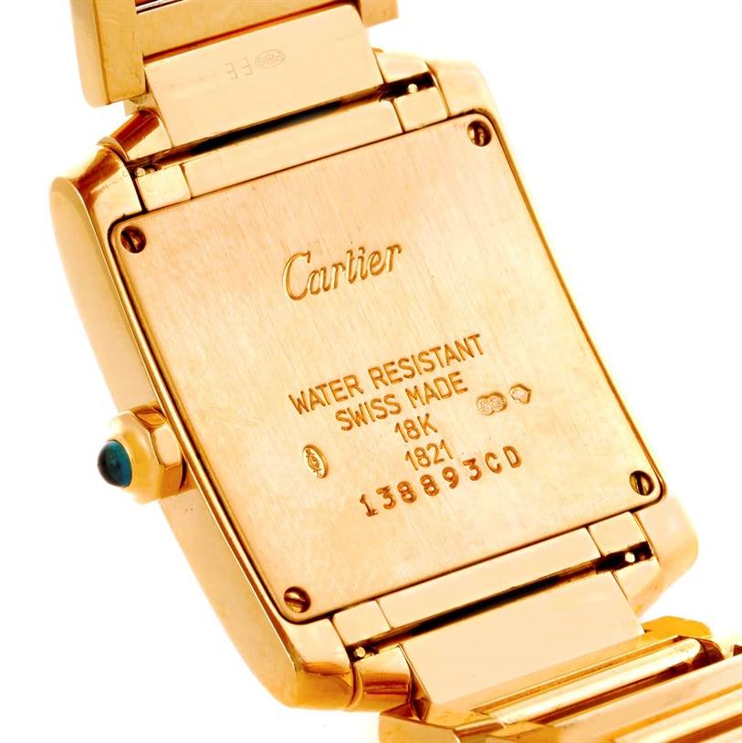 This image shows the back case of a Cartier Tank Francaise W50003N2 Women's Yellow Gold Silver Dial W50003N2 Women's Yellow Gold Silver Dial watch, highlighting its inscriptions and part of the bracelet.
