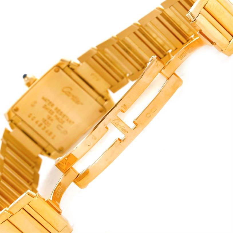The image shows the clasp and case back of a Cartier Tank Française watch in gold, viewed from an angled side perspective.