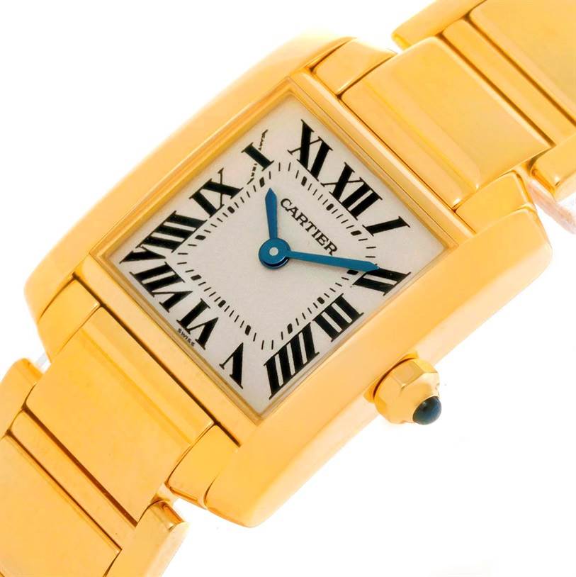 This image shows a close-up view of the Cartier Tank Francaise W50002N2 Women's Yellow Gold Silver Dial W50002N2 Women's Yellow Gold Silver Dial watch face and part of its gold bracelet.