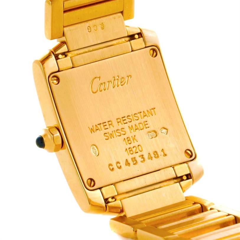 The image shows the back case and part of the bracelet of a Cartier Tank Française watch.