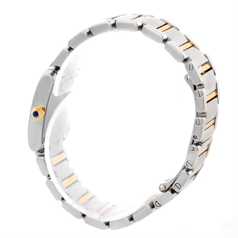 The image shows a side view of a Cartier Tank Française watch with its metal bracelet and crown visible.