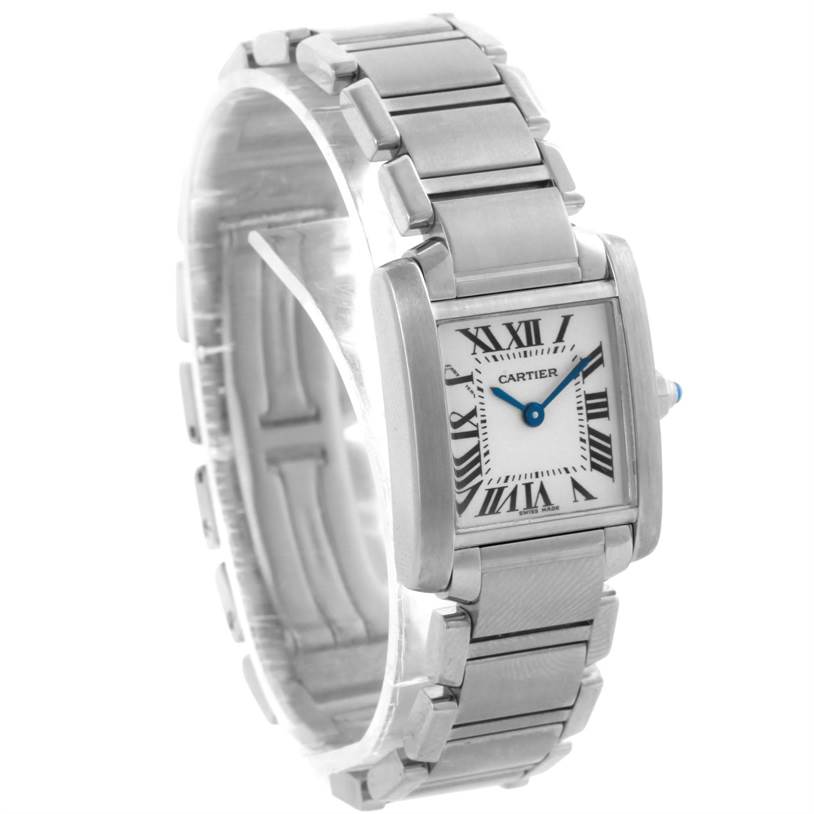 The image shows a three-quarter view of a Cartier Tank Française watch, featuring its rectangular case, white dial, and stainless steel bracelet.