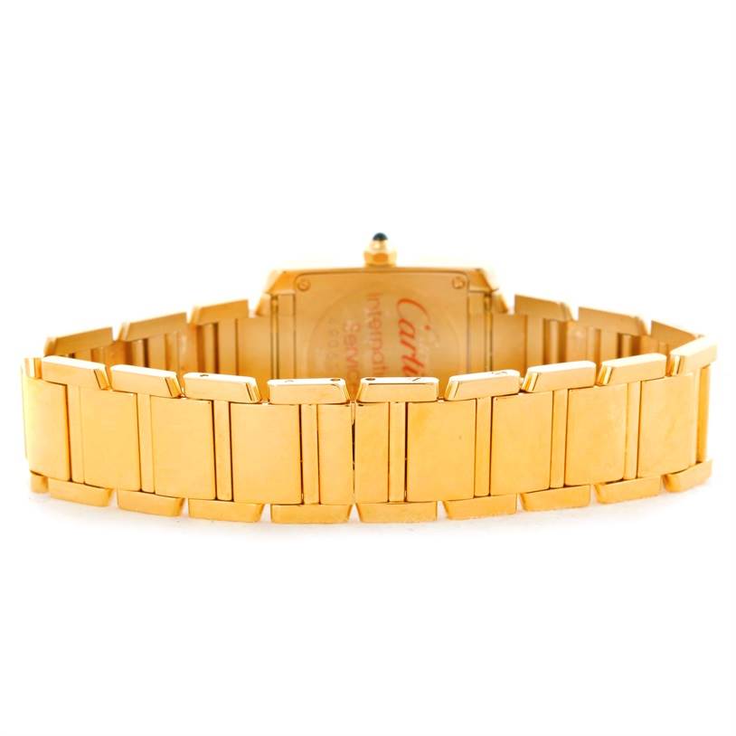 The image shows the back view of the gold bracelet and case of a Cartier Tank Française watch.