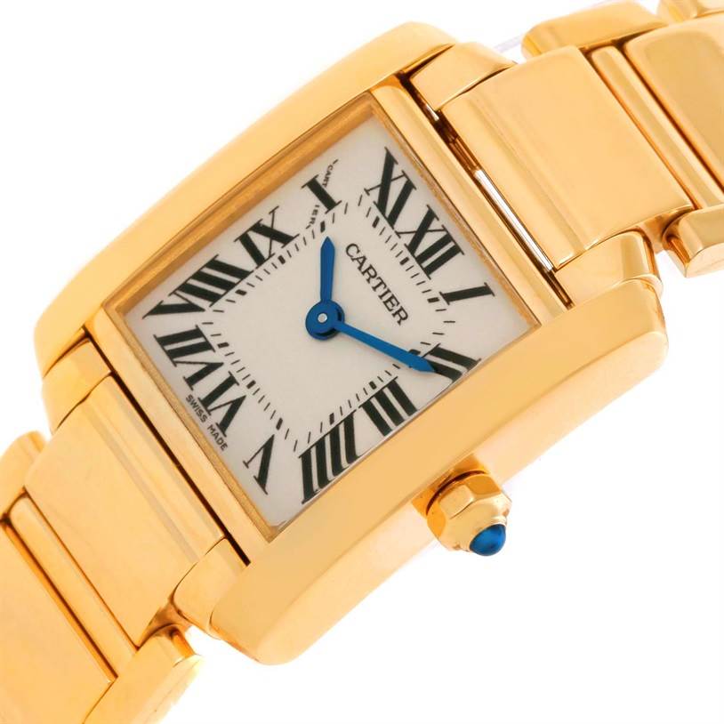 The image shows a close-up of the face, dial, and part of the bracelet of the gold Cartier Tank Française watch.