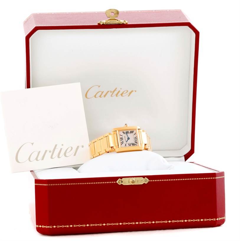 The image shows a Cartier Tank Francaise W50002N2 Women's Yellow Gold Silver Dial W50002N2 Women's Yellow Gold Silver Dial watch in its open case along with a Cartier booklet.