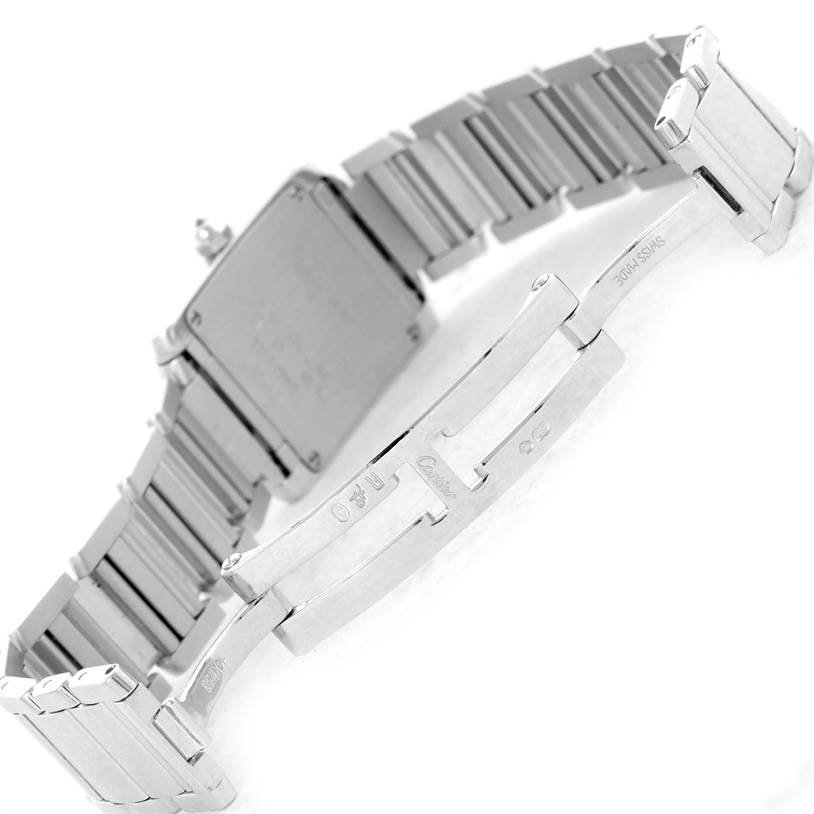 The image shows the rear view of a Cartier Tank Française watch, focusing on its stainless steel bracelet and clasp.