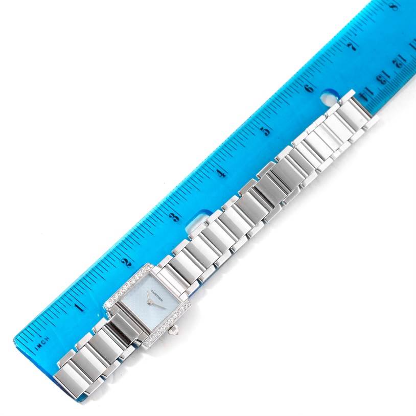 The image shows a Cartier Tank Francaise WE1002S3 Women's White Gold Blue Dial WE1002S3 Women's White Gold Blue Dial watch from a top-down angle, next to a blue ruler for size reference.