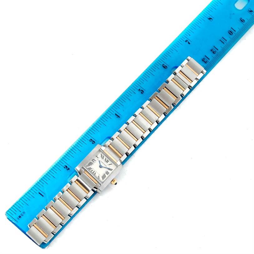 The Cartier Tank Francaise W51007Q4 Women's Steel and Gold (two tone) Silver Dial W51007Q4 Women's Steel and Gold (two tone) Silver Dial watch is shown from an overhead angle with a blue ruler measuring its length.