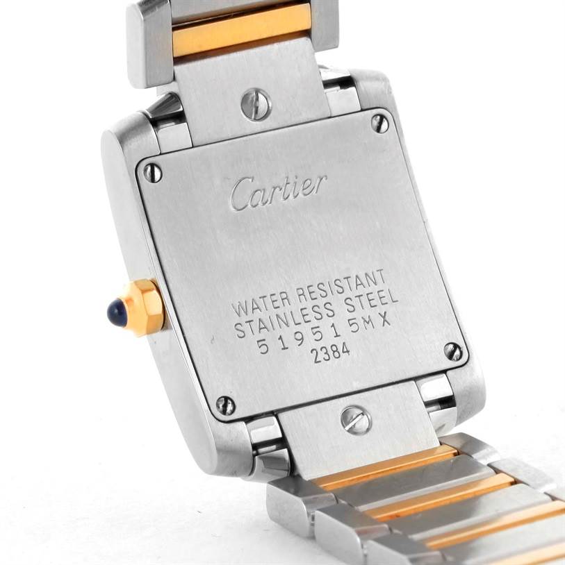 The image shows the case back and part of the bracelet strap of a Tank Française watch by Cartier, with some engraving visible.