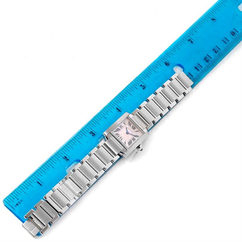 This image shows a Cartier Tank Francaise W51028Q3 Women's Stainless Steel Mother of Pearl Dial W51028Q3 Women's Stainless Steel Mother of Pearl Dial watch laid flat next to a blue ruler.