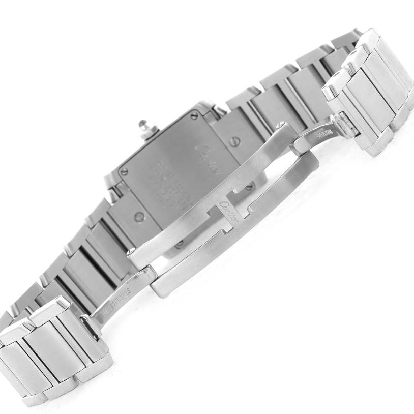 The image shows the backside of the Cartier Tank Française watch, highlighting the stainless steel bracelet and clasp.