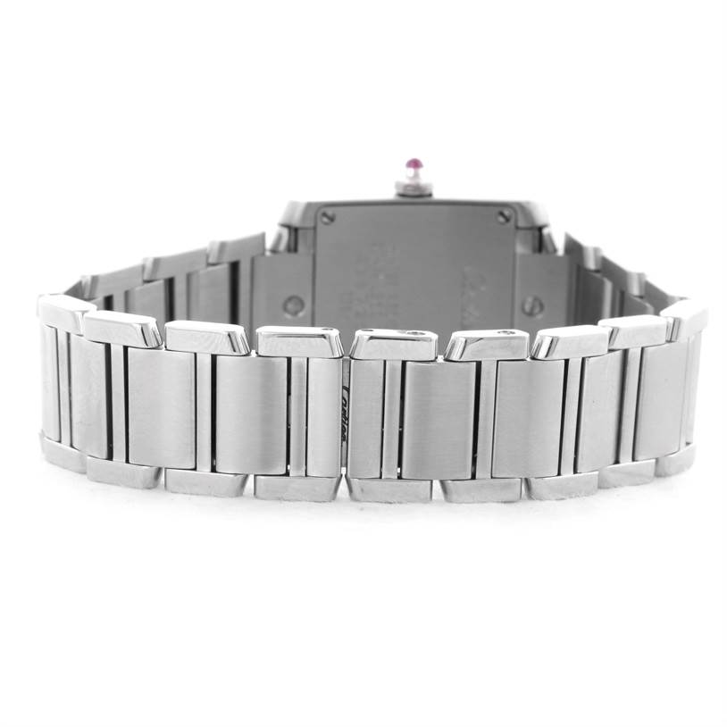 The image shows the back view of a Cartier Tank Française watch, focusing on its metal bracelet and case back.