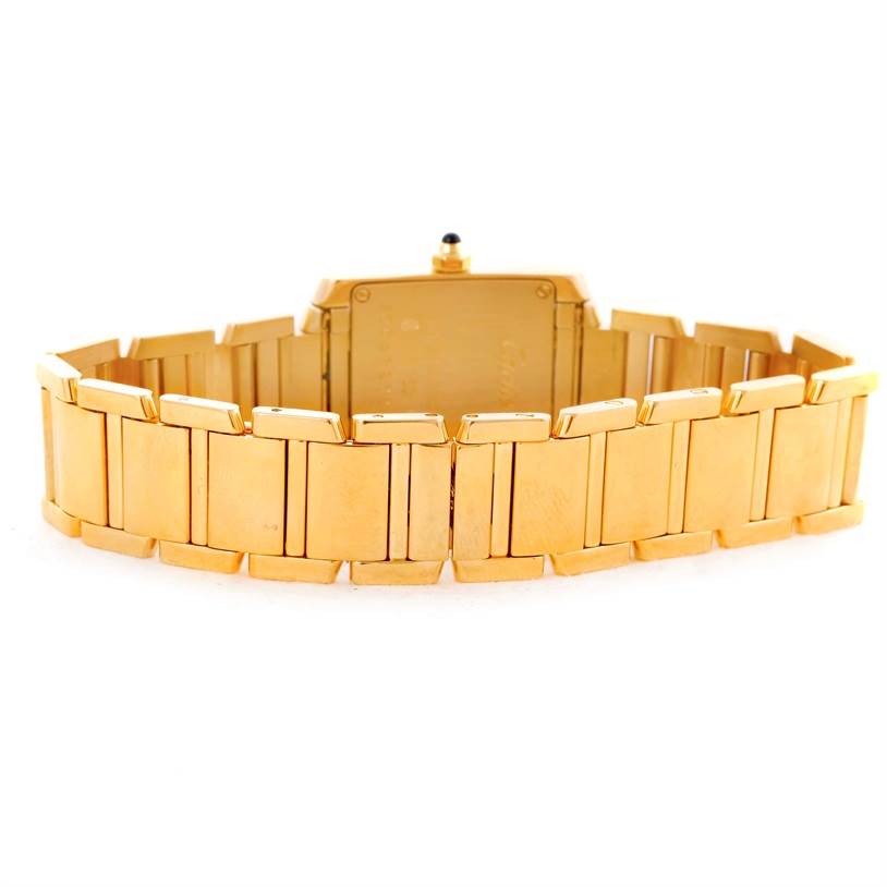 The image shows the back view of a gold Cartier Tank Française watch, highlighting the bracelet and case back.
