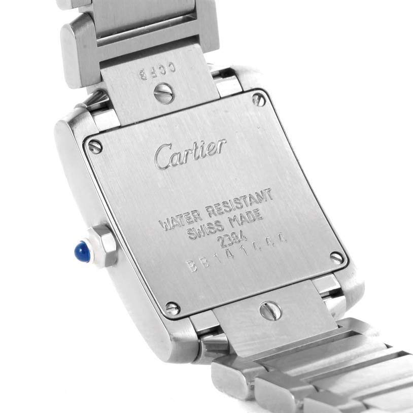 The image shows the back case and part of the bracelet of a Tank Française watch by Cartier.