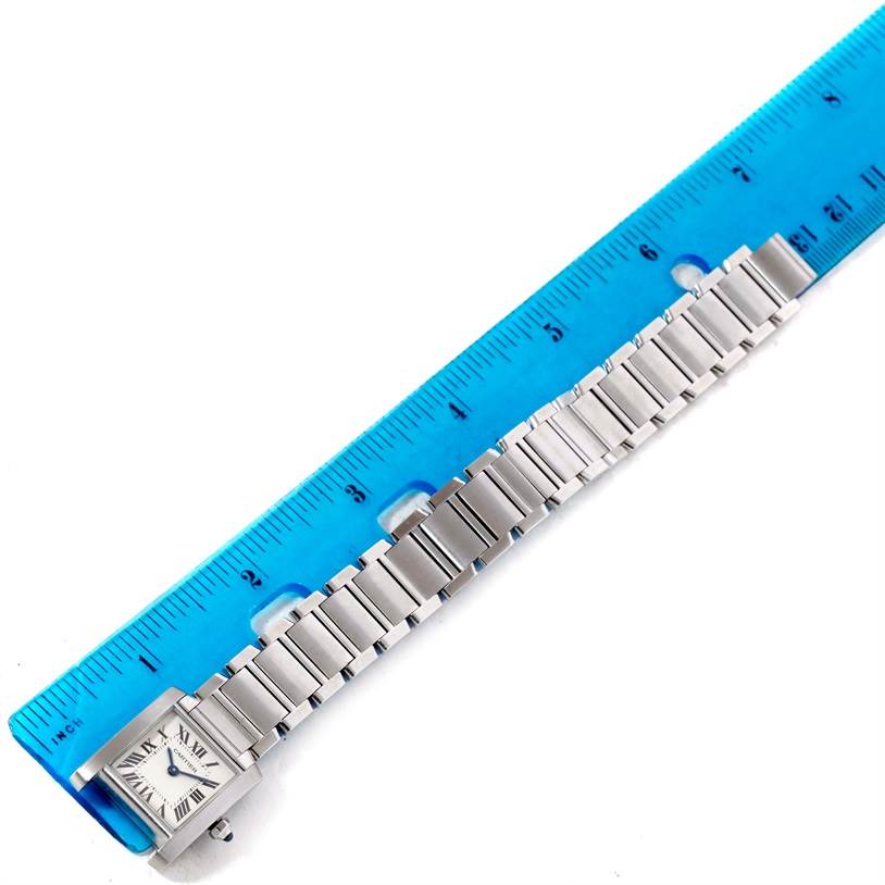 The image shows a Tank Francaise model by Cartier, with the full watch and bracelet laid out alongside a ruler.