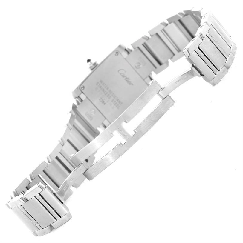 The image shows the back and clasp of a Cartier Tank Française watch, showcasing its stainless steel bracelet.