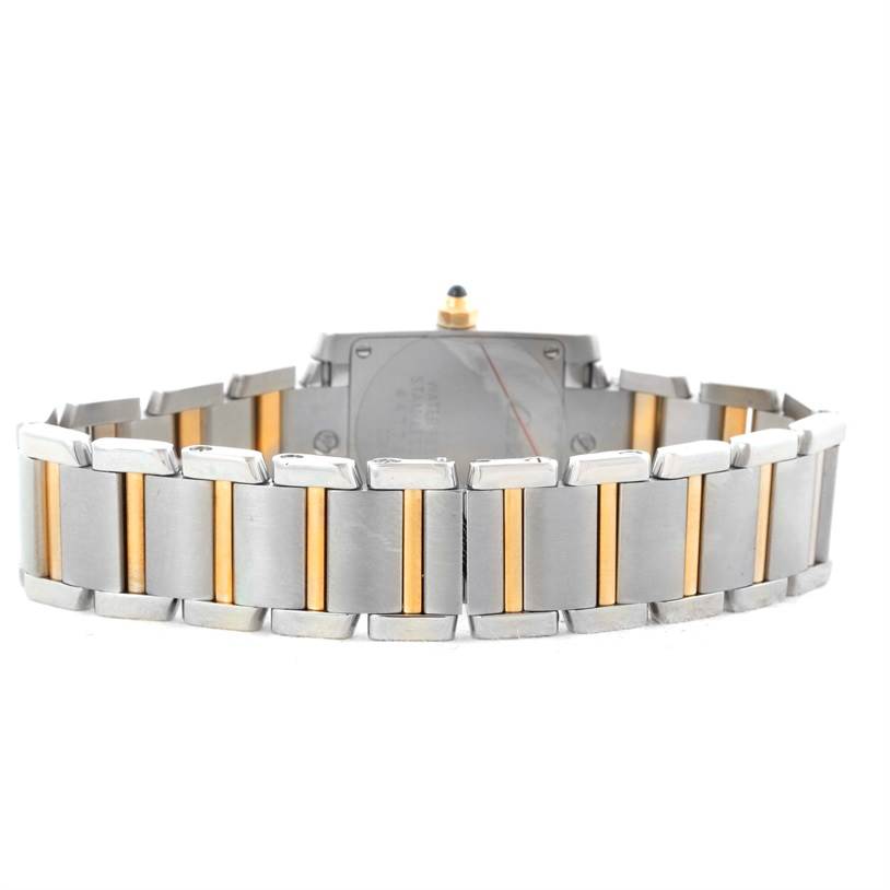 The image shows the back of a Cartier Tank Française watch, focusing on the two-tone metal bracelet and case back.