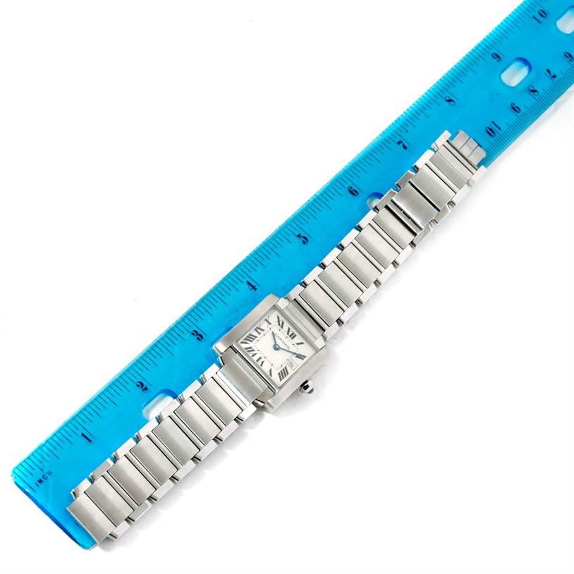 This image shows a top-down view of the Cartier Tank Francaise W51011Q3 Women's Stainless Steel White Dial W51011Q3 Women's Stainless Steel White Dial watch, aligned next to a blue ruler for measurement.