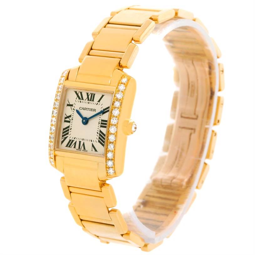 The image shows a Cartier Tank Francaise WE1001R8 Women's Yellow Gold Silver Dial WE1001R8 Women's Yellow Gold Silver Dial watch angled slightly to showcase the diamond-studded bezel, face, and gold bracelet.
