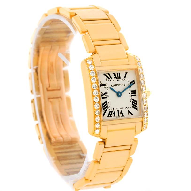 The image shows a Cartier Tank Francaise WE1001R8 Women's Yellow Gold Silver Dial WE1001R8 Women's Yellow Gold Silver Dial watch from an angled side view, highlighting its gold bracelet, rectangular face, and diamond-studded bezel.