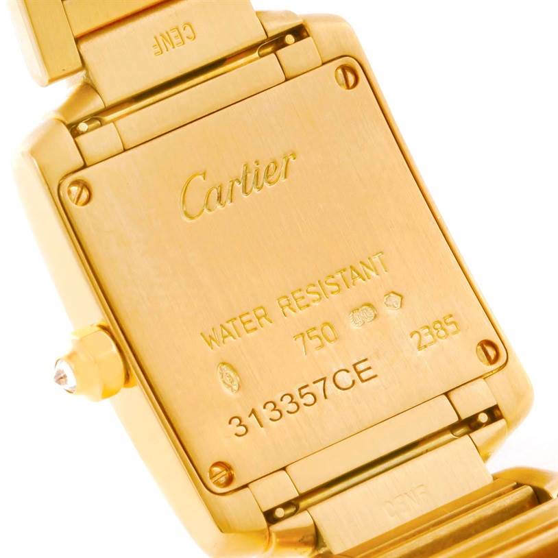 The image shows the back of a Cartier Tank Francaise WE1001R8 Women's Yellow Gold Silver Dial WE1001R8 Women's Yellow Gold Silver Dial watch, focusing on its case and engravings.