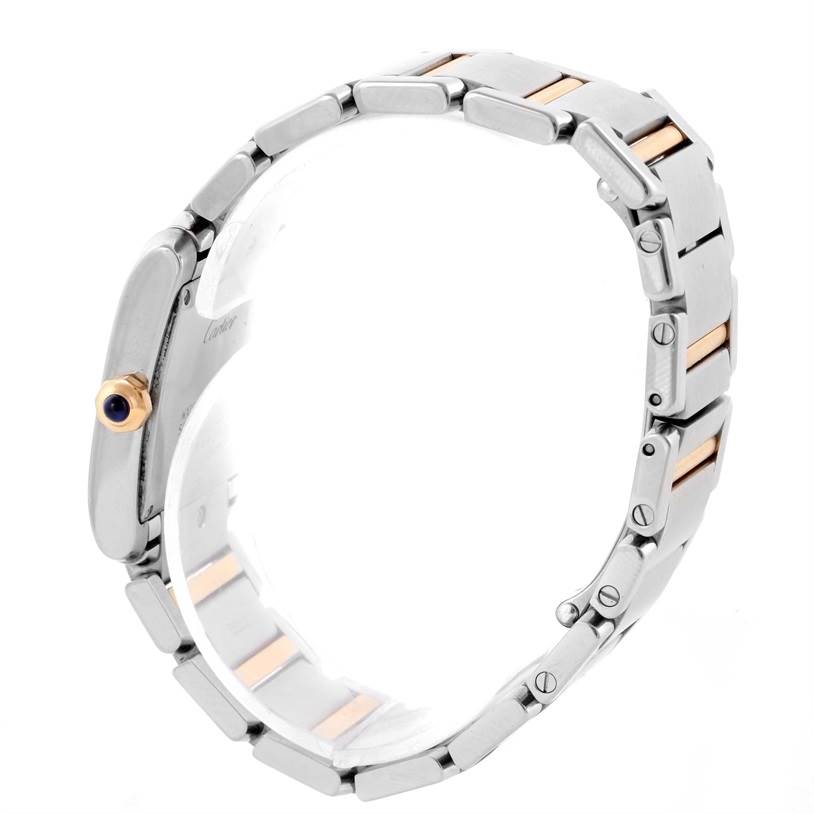 The side view of the Cartier Tank Francaise W51012Q4 Women's Steel and Gold (two tone) Silver Dial W51012Q4 Women's Steel and Gold (two tone) Silver Dial watch shows its bracelet and the crown with a blue gem.