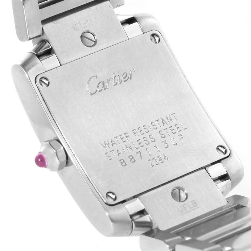 The image shows the back case of a Cartier Tank Française watch, highlighting its inscriptions and metal bracelet.