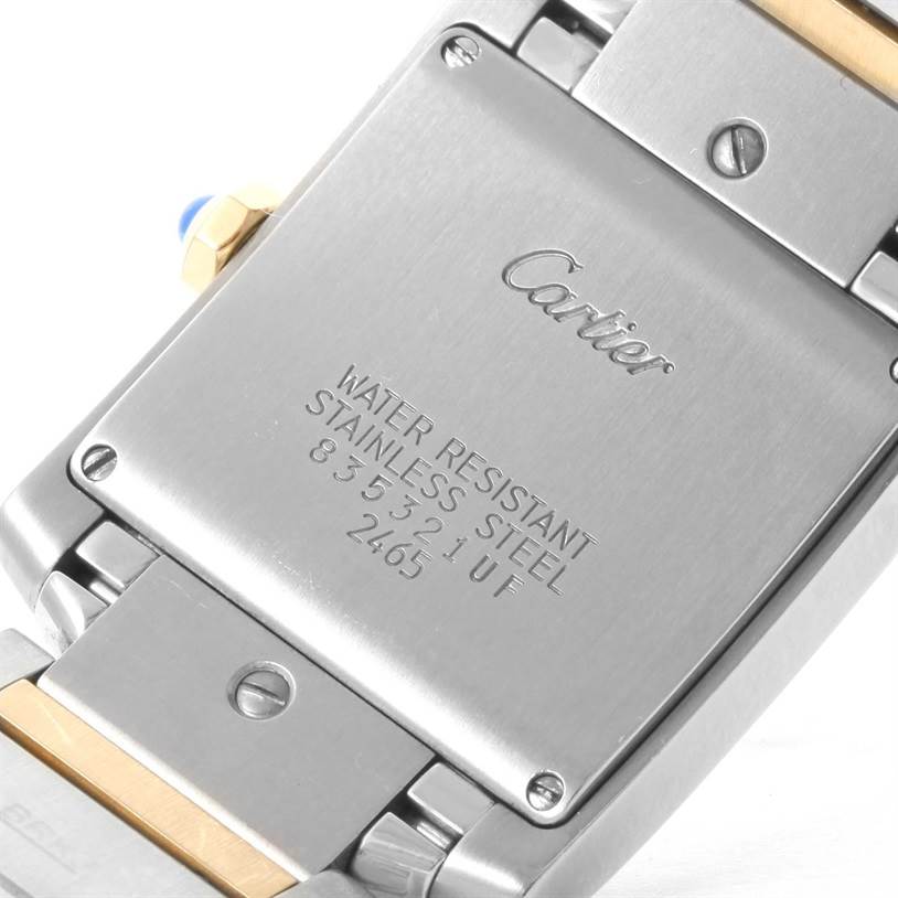 The image shows the back case and part of the bracelet of a Cartier Tank Francaise W51012Q4 Women's Steel and Gold (two tone) Silver Dial W51012Q4 Women's Steel and Gold (two tone) Silver Dial watch, highlighting engravings and screws.