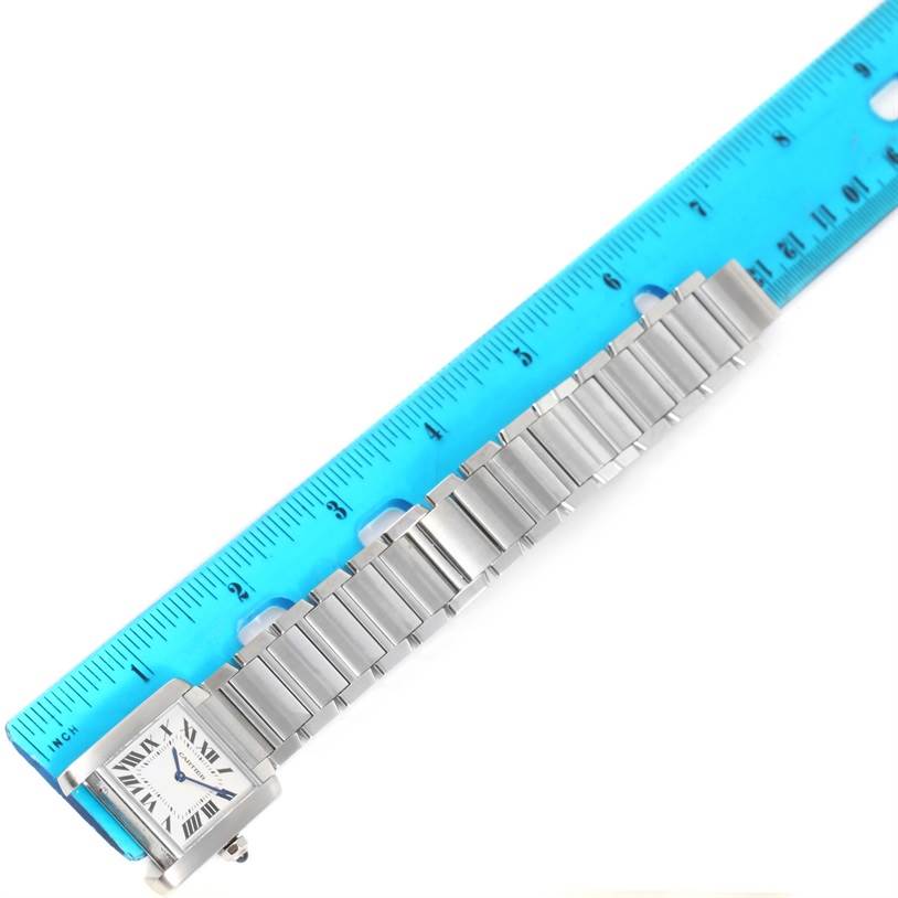 The image shows the Cartier Tank Francaise WSTA0005 Women's Stainless Steel Silver Dial WSTA0005 Women's Stainless Steel Silver Dial watch laid flat next to a blue ruler, showcasing the watch face and metal bracelet.