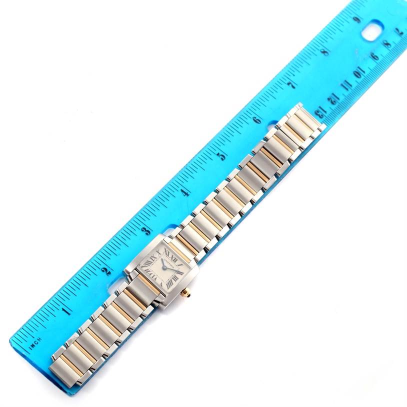 The Cartier Tank Francaise W51007Q4 Women's Steel and Gold (two tone) Silver Dial W51007Q4 Women's Steel and Gold (two tone) Silver Dial watch is shown from above, displaying its face, bracelet, and a blue ruler for scale.