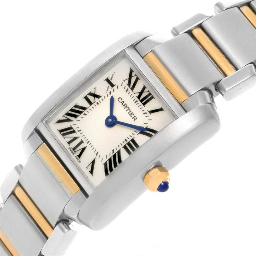 This image shows a close-up of the dial, crown, and bracelet of a Cartier Tank Française watch at a tilted angle.