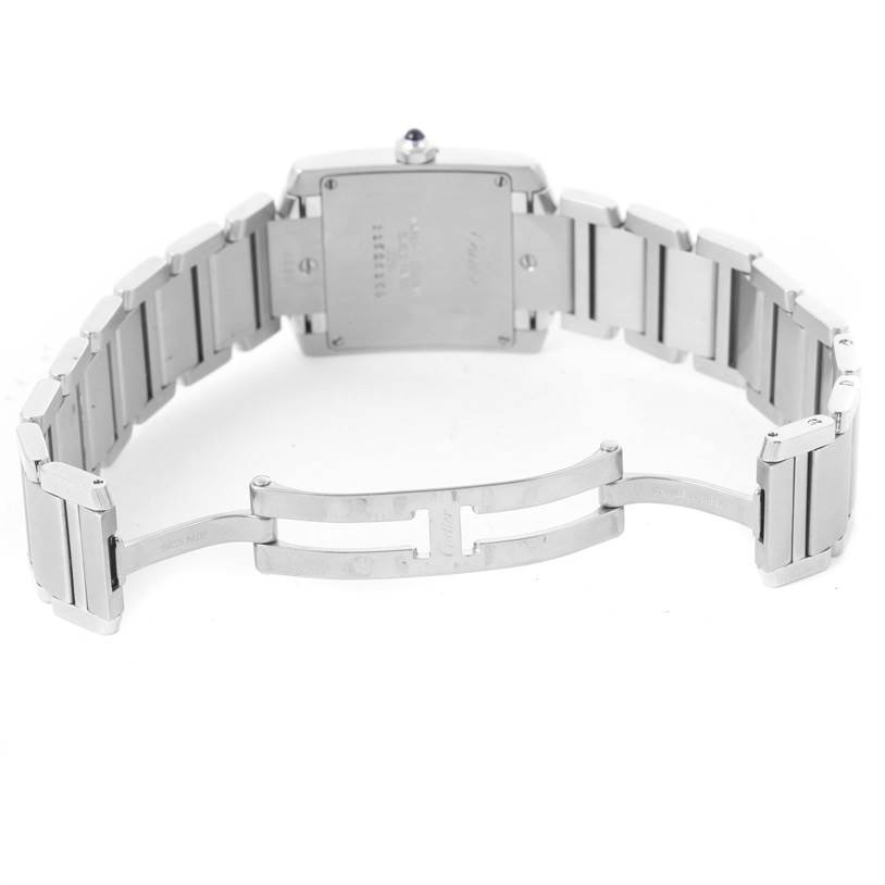 The image shows a rear view of a Cartier Tank Française watch with the bracelet clasp open.