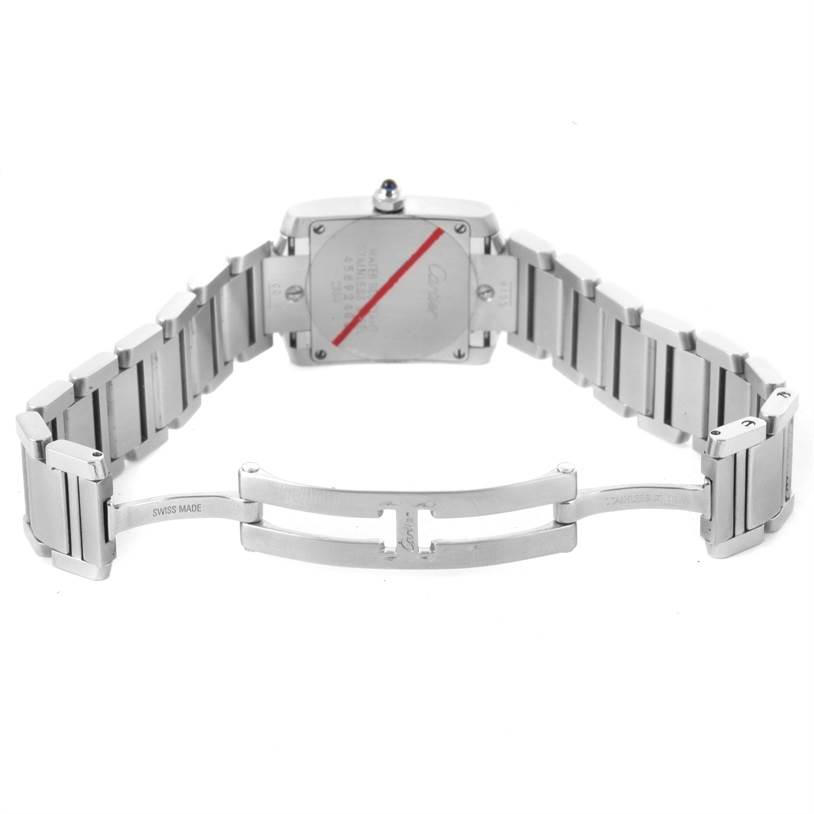 The image shows the back of a Cartier Tank Francaise W51008Q3 Women's Stainless Steel Silver Dial W51008Q3 Women's Stainless Steel Silver Dial watch and its open metal bracelet clasp.