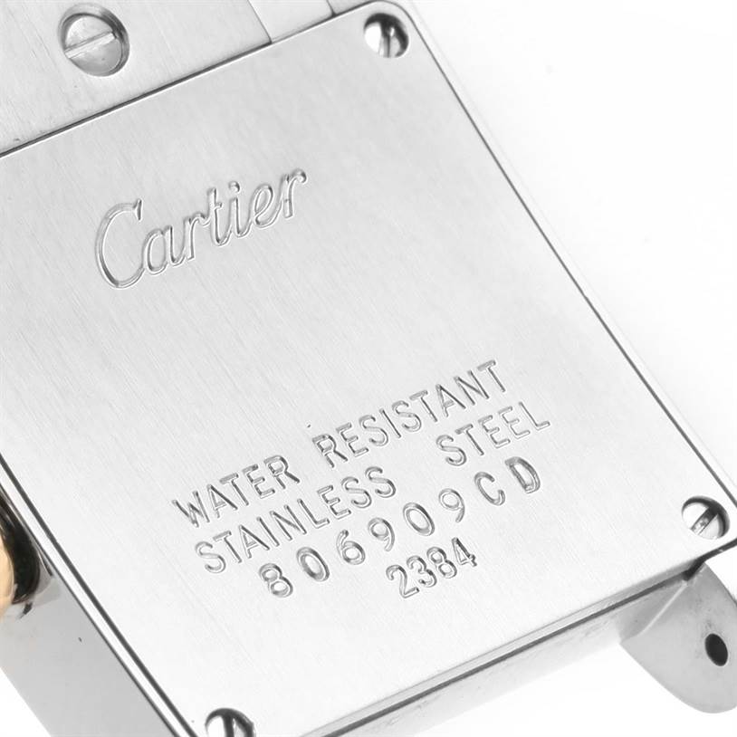 This image shows the back plate of a Cartier Tank Francaise W51007Q4 Women's Steel and Gold (two tone) Silver Dial W51007Q4 Women's Steel and Gold (two tone) Silver Dial watch, highlighting engravings and serial numbers.
