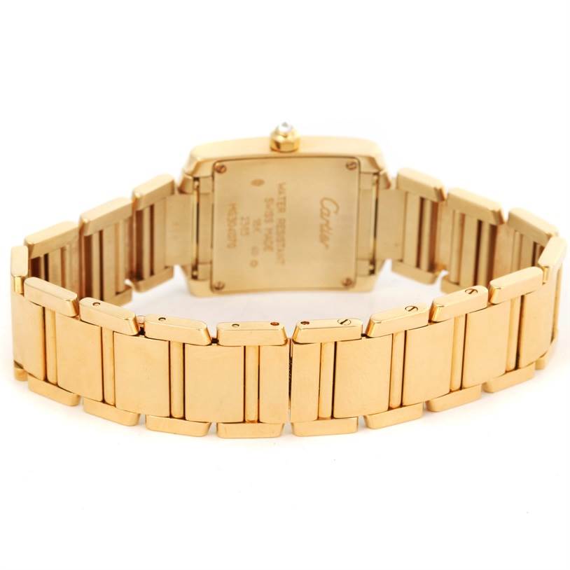 This image shows the back case and full bracelet of a Cartier Tank Francaise WE1001R8 Women's Yellow Gold Silver Dial WE1001R8 Women's Yellow Gold Silver Dial watch, angled to display the clasp and case back details.
