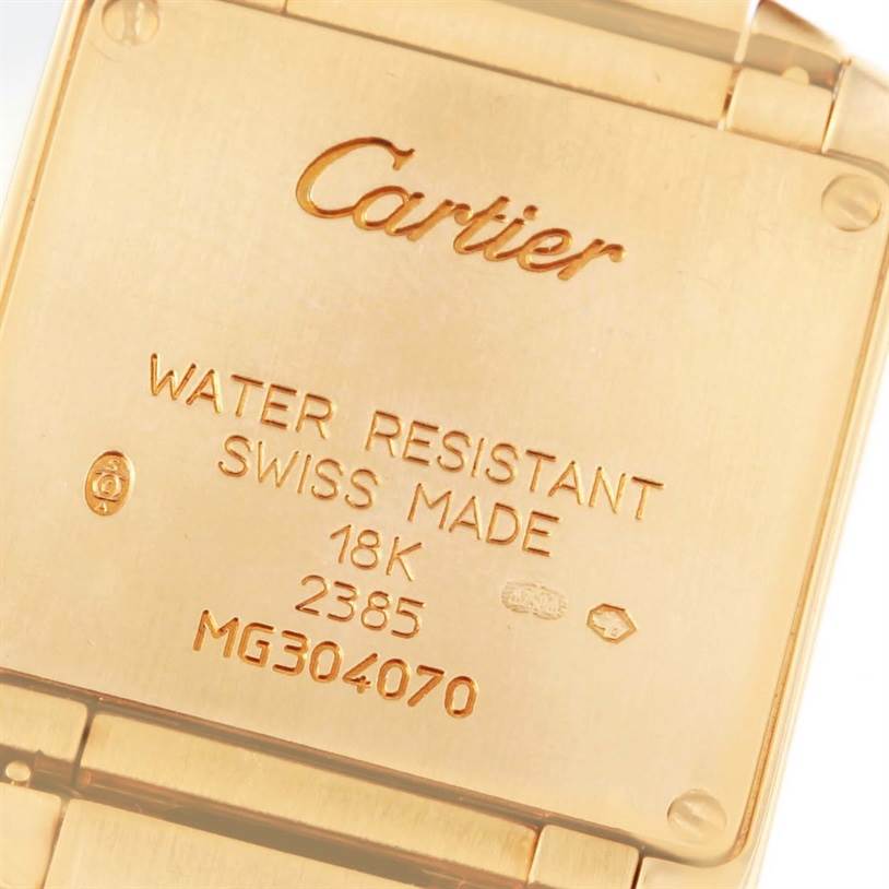 This image shows the back case of a Cartier Tank Française watch, displaying inscriptions of its specifications and serial number.