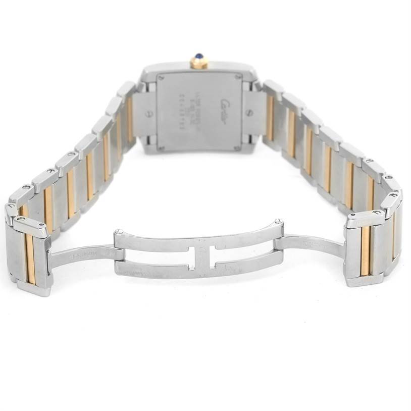 This image shows the back case and the open clasp of the Cartier Tank Française watch, highlighting its metal strap.