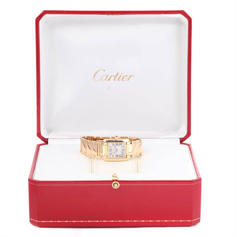 The Cartier Tank Francaise W50002N2 Women's Yellow Gold Silver Dial W50002N2 Women's Yellow Gold Silver Dial watch is positioned frontally inside its open red and white display box.