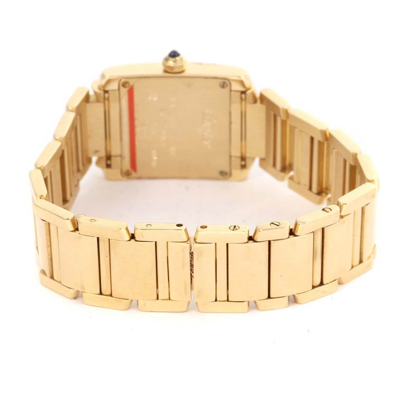 The image shows the back view of a Cartier Tank Francaise W50002N2 Women's Yellow Gold Silver Dial W50002N2 Women's Yellow Gold Silver Dial watch, highlighting its gold bracelet and case back.