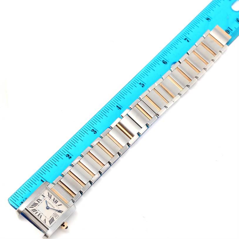 The image shows the full length of the Tank Francaise watch by Cartier, specifically focusing on the bracelet next to a ruler for measurement.