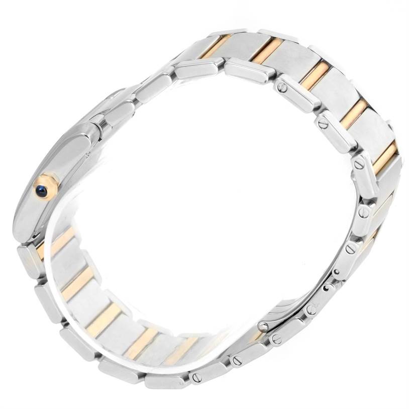 The image shows the bracelet of a Cartier Tank Française watch, highlighting the linked metallic and gold-tone design from an angled view.