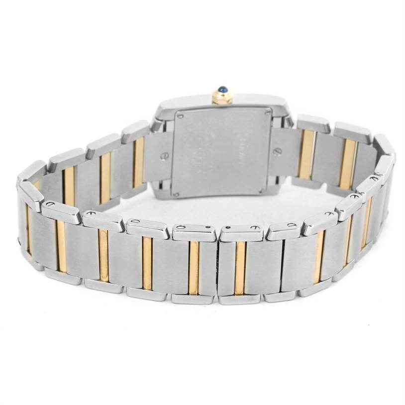 The image shows the back view of a Cartier Tank Française watch, highlighting its two-tone metal bracelet and caseback.