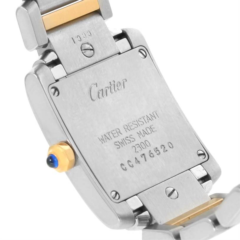 The image shows the back of a Cartier Tank Francaise W51007Q4 Women's Steel and Gold (two tone) Silver Dial W51007Q4 Women's Steel and Gold (two tone) Silver Dial watch, including the bracelet links and crown with a blue cabochon.