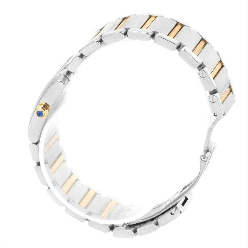 The image shows a side view of the Tank Francaise watch by Cartier, highlighting its metal bracelet and blue cabochon crown.