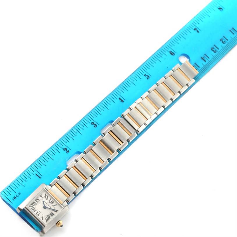 The Cartier Tank Francaise W51007Q4 Women's Steel and Gold (two tone) Silver Dial W51007Q4 Women's Steel and Gold (two tone) Silver Dial watch is shown from the top, alongside a measuring ruler, highlighting its watch face and bracelet.