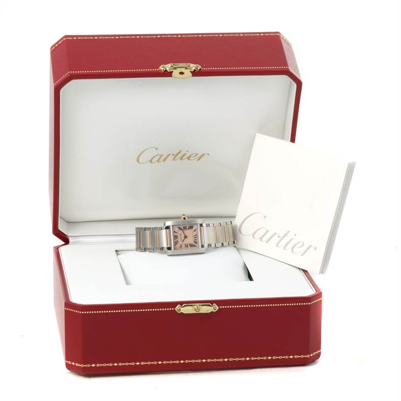 The image shows a Cartier Tank Française watch placed inside a red Cartier box, with a booklet on the side.