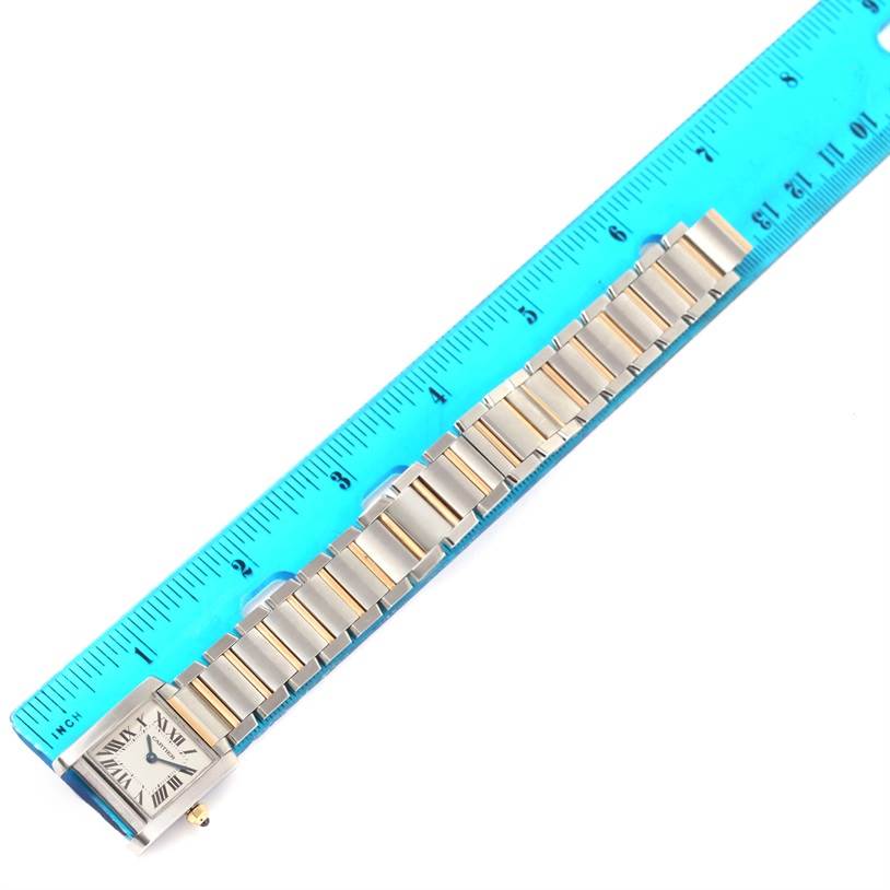The image shows a Cartier Tank Francaise W51007Q4 Women's Steel and Gold (two tone) Silver Dial W51007Q4 Women's Steel and Gold (two tone) Silver Dial watch laid flat next to a blue ruler, highlighting the watchband's length.
