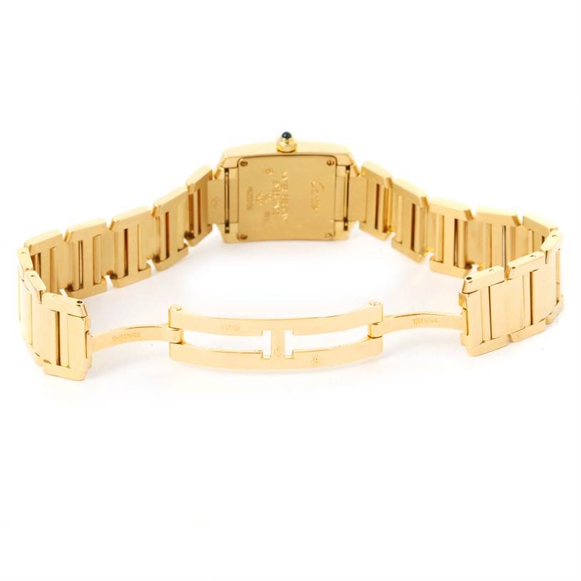 The image shows the backside and bracelet of a Cartier Tank Française watch, with the folding clasp open.