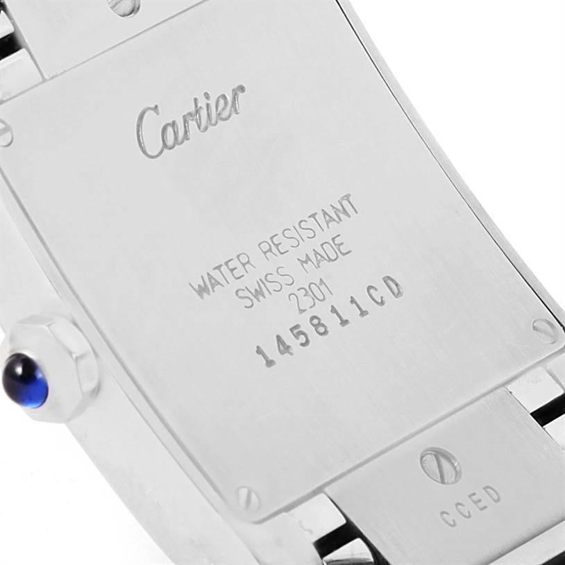 This image shows the case back of a Cartier Tank Française watch, highlighting the engraved details and the crown side.